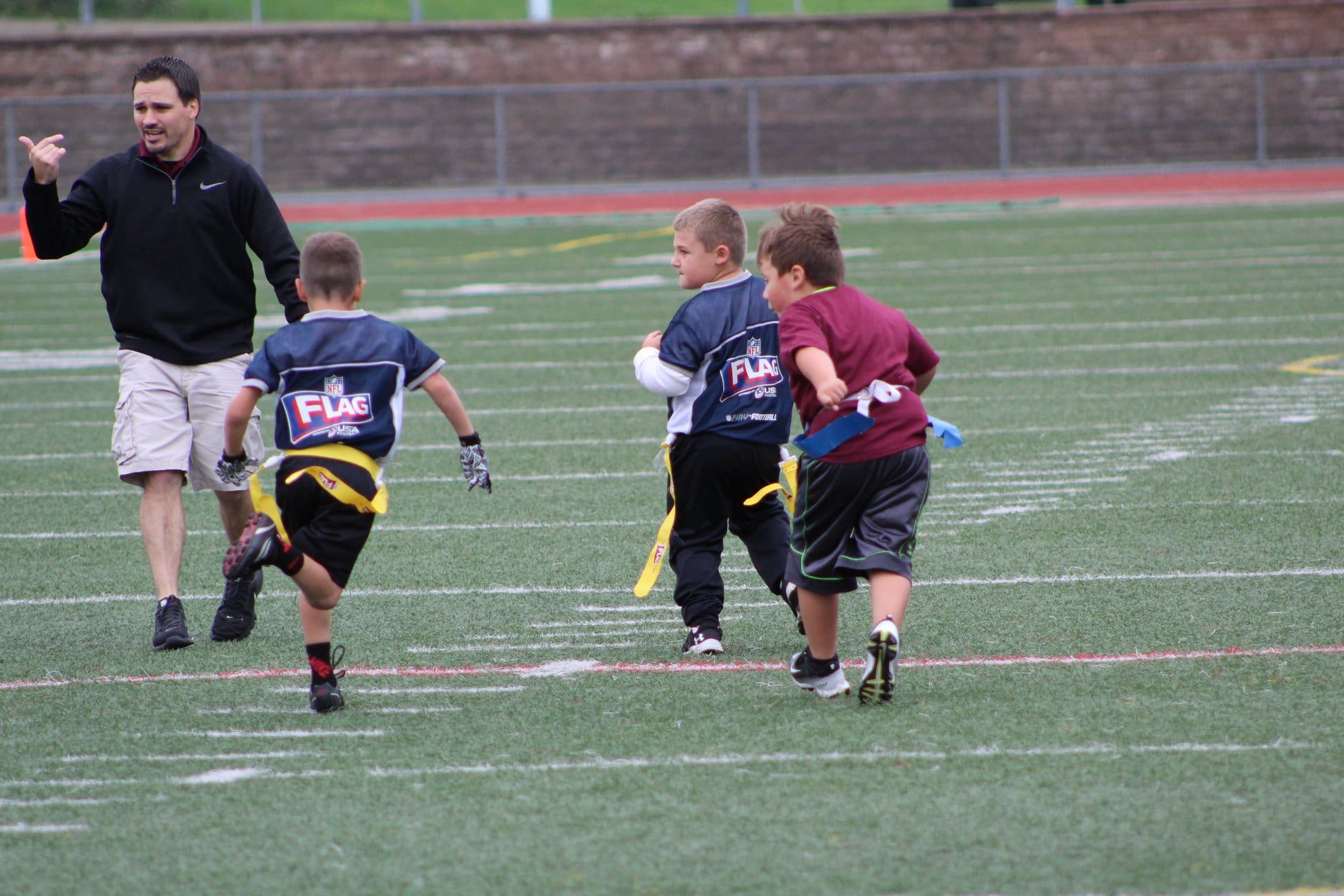 Kyle Youngs coaching a youth sports team. 